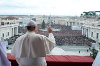 Pope Francis waves as he delivers his first "Urbi et Orbi" (to the city and world) message from the balcony overlooking St. Peter's Square at the Vatican December 25, 2013. Francis, celebrating his first Christmas as Roman Catholic leader, on Wednesday called for dialogue to end the conflict in South Sudan and all wars, saying everyone should strive to be personal peacemakers. REUTERS/Osservatore Romano (VATICAN - Tags: RELIGION) ATTENTION EDITORS - NO SALES. NO ARCHIVES. FOR EDITORIAL USE ONLY. NOT FOR SALE FOR MARKETING OR ADVERTISING CAMPAIGNS. THIS IMAGE HAS BEEN SUPPLIED BY A THIRD PARTY. IT IS DISTRIBUTED, EXACTLY AS RECEIVED BY REUTERS, AS A SERVICE TO CLIENTS