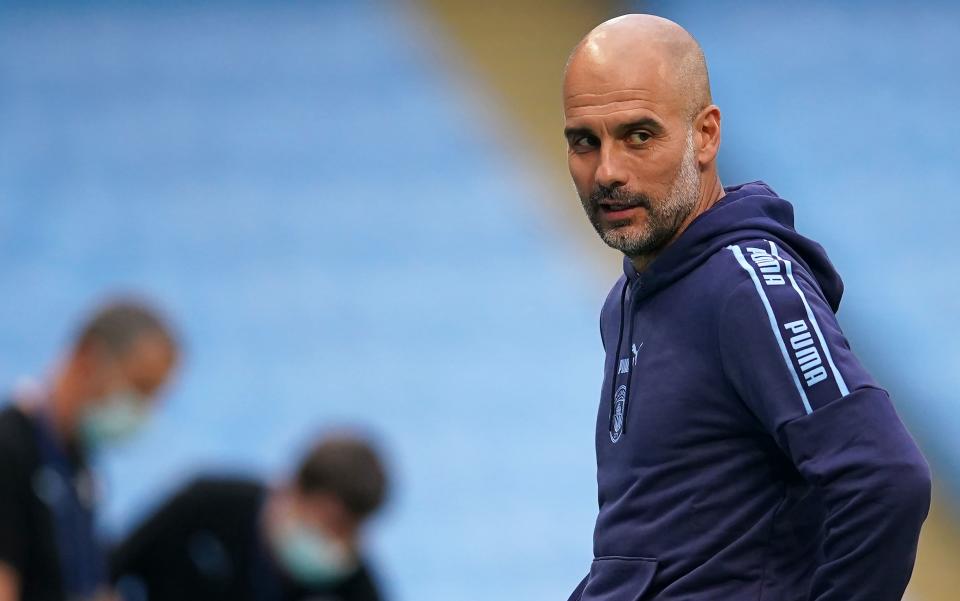 Manchester City's Spanish manager Pep Guardiola reacts in front of empty stands ahead of the English Premier League football match between Manchester City and Arsenal at the Etihad Stadium in Manchester, north west England, on June 17, 2020. - The Premier League makes its eagerly anticipated return today after 100 days in lockdown but behind closed doors due to coronavirus restrictions. (Photo by DAVE Thompson / POOL / AFP) / RESTRICTED TO EDITORIAL USE. No use with unauthorized audio, video, data, fixture lists, club/league logos or 'live' services. Online in-match use limited to 120 images. An additional 40 images may be used in extra time. No video emulation. Social media in-match use limited to 120 images. An additional 40 images may be used in extra time. No use in betting publications, games or single club/league/player publications. /  (Photo by DAVE THOMPSON/POOL/AFP via Getty Images)