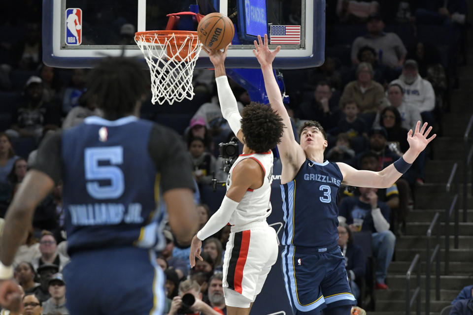 Memphis Grizzlies forward Jake LaRavia (3) defends against Portland Trail Blazers guard Matisse Thybulle, center, in the first half of an NBA basketball game Friday, March 1, 2024, in Memphis, Tenn. (AP Photo/Brandon Dill)