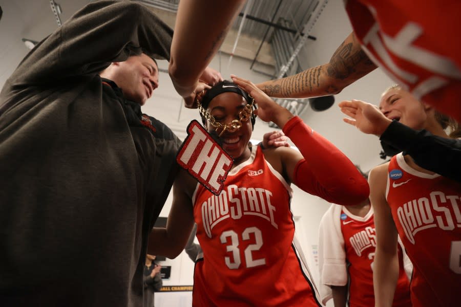 SEATTLE, WASHINGTON – MARCH 25: Cotie McMahon #32 and Head coach Kevin McGuff of the Ohio State Buckeyes and teammates celebrate after defeating the UConn Huskies 73-61 in the Sweet 16 round of the NCAA Women’s Basketball Tournament at Climate Pledge Arena on March 25, 2023 in Seattle, Washington. (Photo by Steph Chambers/Getty Images)