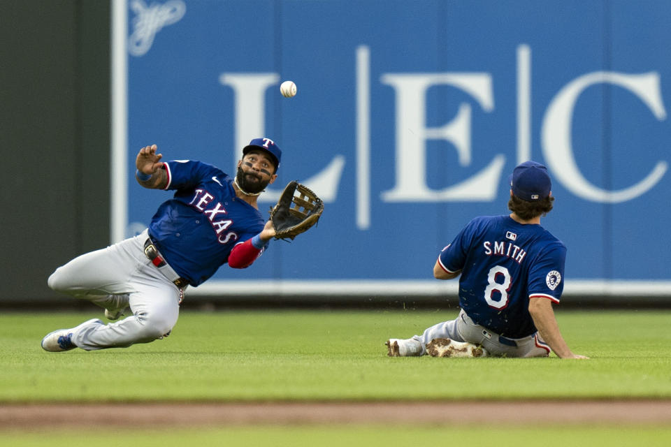 Texas Rangers right fielder Derek Hill, left, with backup from third baseman Josh Smith (8), catches a fly ball hit by Baltimore Orioles' Cedric Mullins during the second inning of a baseball game Thursday, June 27, 2024, in Baltimore. (AP Photo/Stephanie Scarbrough)