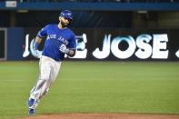 Oct 14, 2015; Toronto, Ontario, CAN; Toronto Blue Jays right fielder Jose Bautista (19) runs the bases after hitting a home run against the Texas Rangers in game five of the ALDS at Rogers Centre. Mandatory Credit: Nick Turchiaro-USA TODAY Sports