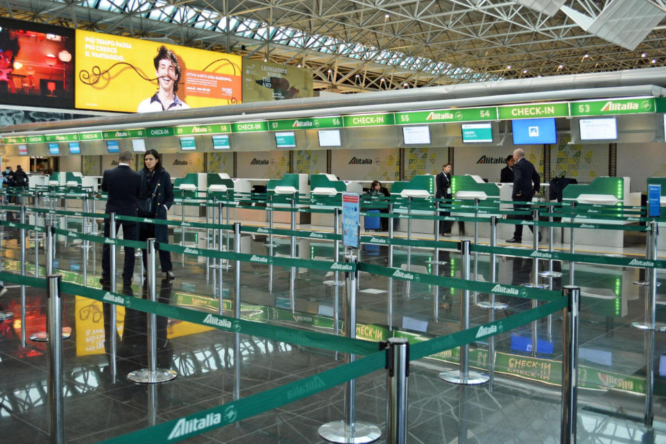 The Alitalia check-in area is empty at Rome's Leonardo Da Vinci international airport, in Fiumicino, near Rome, Friday, Dec. 13, 2019. As its workers went on nationwide air sector strike on Friday, grounding hundreds of flights, the fate of Italy’s national carrier Alitalia still hangs in the balance. (Telenews/ANSA via AP)