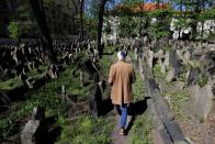 Leo Pavlat, director of the Jewish Museum, walks through the Old Jewish Cemetery in Prague