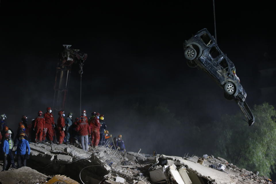 Members of rescue services work on the debris of a collapsed building in Izmir, Turkey, Sunday, Nov. 1, 2020. Rescue teams continue ploughing through concrete blocs and debris of collapsed buildings in Turkey's third largest city in search of survivors of a powerful earthquake that struck Turkey's Aegean coast and north of the Greek island of Samos, Friday Oct. 30, killing dozens Hundreds of others were injured.(AP Photo/Emrah Gurel)