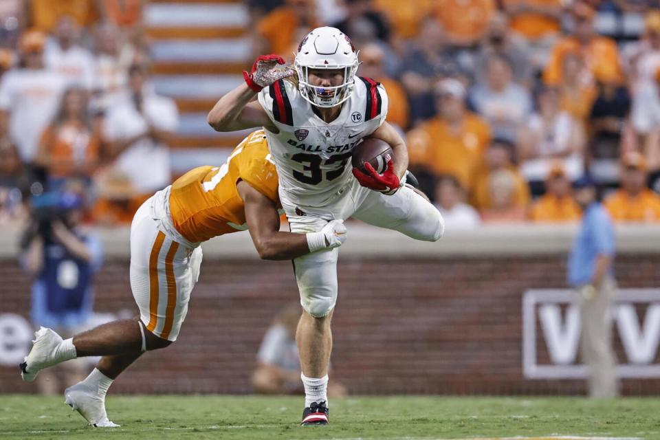 Ball State running back Carson Steele is tackled by Tennessee linebacker Aaron Beasley during a game in September.