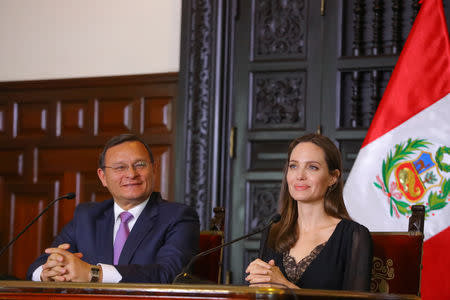 Peruvian Foreign Minister Nestor Popolizio (L) attends a news conference with U.N. Refugee Agency’s special envoy Angelina Jolie at the government palace in Lima, Peru October 23, 2018. Courtesy of Peruvian Government Palace/Andres Valle/Handout via REUTERS