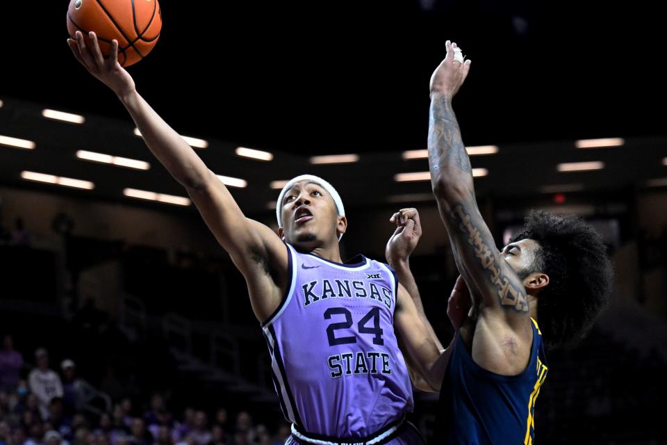 Kansas State guard Nijel Pack (24) shoots next to West Virginia forward Isaiah Cottrell during the second half of an NCAA college basketball game in Manhattan, Kan., Monday, Feb. 14, 2022. (AP Photo/Reed Hoffmann)