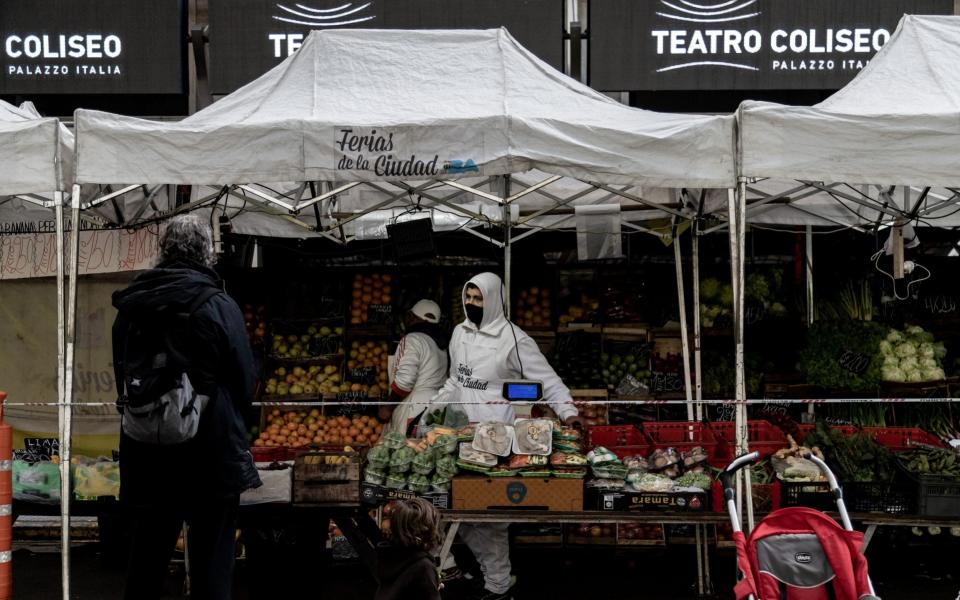 As Infections Spike Across Argentina Original description: Customers shop for produce at a vendor stall in a market in the Recoleta neighborhood of Buenos Aires, Argentina, - Bloomberg