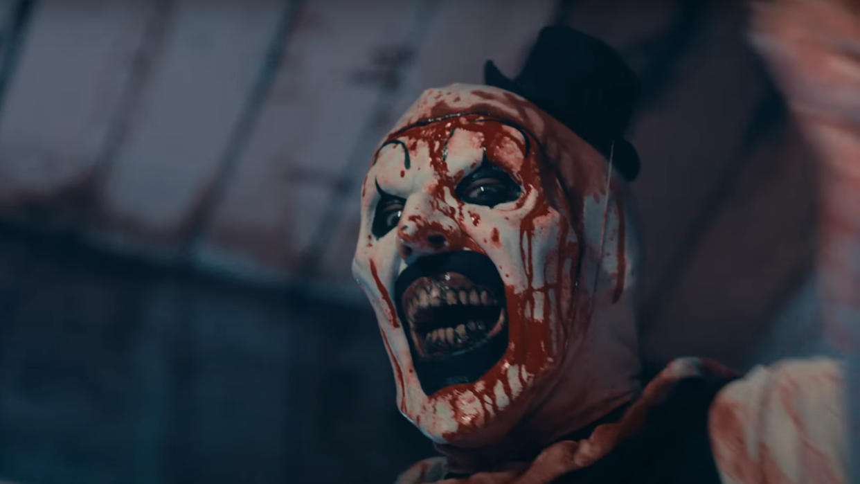  David Howard Thornton smiles while splattered with blood in Terrifier 2. 