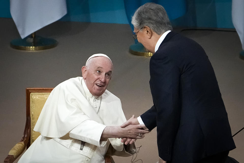 Kazakhstan's President Kassym-Jomart Tokayev, right, greets Pope Francis as he arrives at a meeting with authorities, civil society and diplomats at Qazaq Concert Hall in Nur-Sultan, Kazakhstan, Tuesday, Sept. 13, 2022. Pope Francis begins a 3-days visit to the majority-Muslim former Soviet republic to minister to its tiny Catholic community and participate in a Kazakh-sponsored conference of world religious leaders. (AP Photo/Alexander Zemlianichenko)