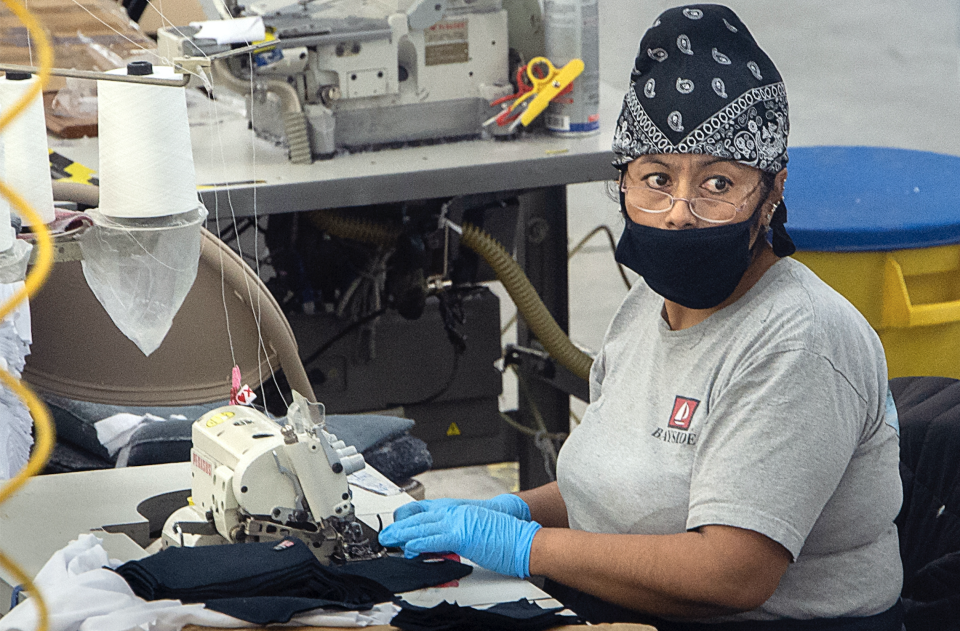 Employees at AST Sportswear in Brea, CA switch from making T-shirts to making masks to meet the coronavirus demand on Tuesday, March 24, 2020.(Photo: Mindy Schauer/MediaNews Group/Orange County Register via Getty Images)