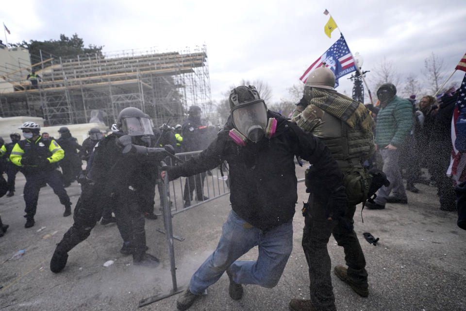 Trump supporters try to break through a police barrier, Wednesday, Jan. 6, 2021, at the Capitol in Washington. As Congress prepares to affirm President-elect Joe Biden's victory, thousands of people have gathered to show their support for President Donald Trump and his claims of election fraud. (AP Photo/Julio Cortez)