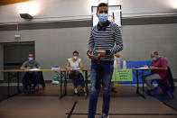 A man wears a face mask to help curb the spread of the coronavirus at a polling station during the Basque regional election in the village of Durango, northern Spain, Sunday, July 12, 2020. Basque authorities are displaying special rules and practices in the protection against the coronavirus. (AP Photo/Alvaro Barrientos)