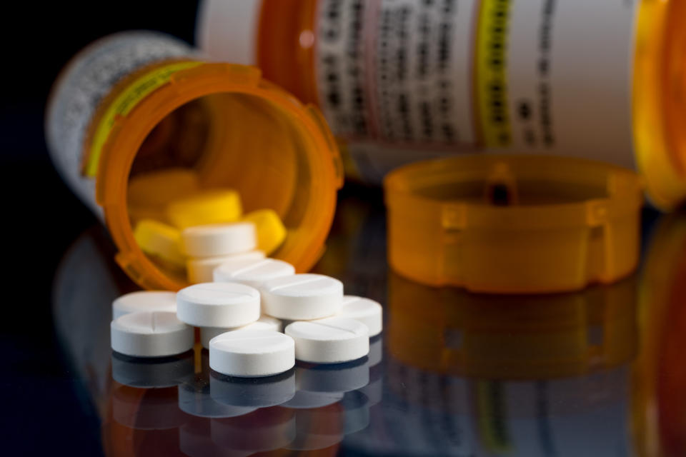 an open pill bottle with pills on the table