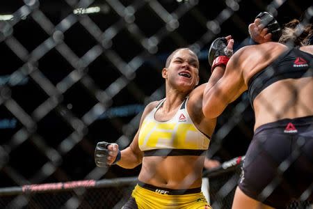 Jul 9, 2016; Las Vegas, NV, USA; Amanda Nunes (blue gloves) punches Miesha Tate (red gloves) during UFC 200 at T-Mobile Arena. Nunez won by rear naked choke. Mandatory Credit: Joshua Dahl-USA TODAY Sports