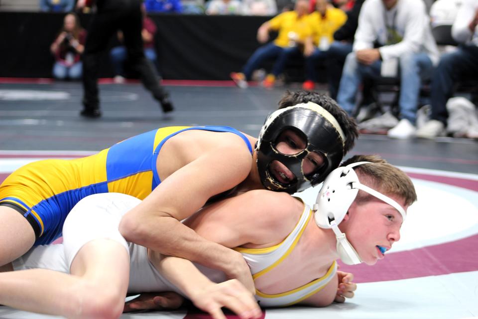 Dolores Huerta's Miguel Franco maintains top control over Carter Jensen of Highland during their Class 2A 106-pound matchup of the CHSAA state wrestling tournament on Thursday, Feb. 15, 2024.