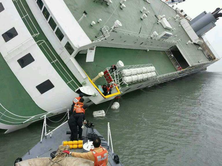 The South Korean Coast Guard rescue some of the passengers from a ferry sinking some 20 kilometres off the island of Byungpoong in Jindo on April 16, 2014, in this South Korea Coast Guard image