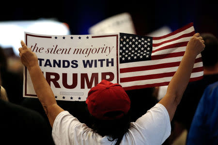 A supporter of Republican U.S. presidential nominee Donald Trump holds a sign at a Trump campaign rally in West Palm Beach, Florida, U.S., October 13, 2016. REUTERS/Mike Segar