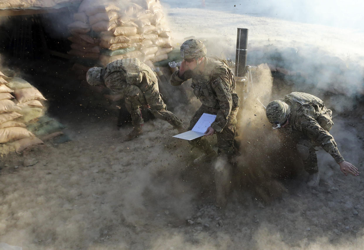 U.S. soldiers of B Troop, 1st squadron of 4th US Cavalry Regiment, fire a 120 mm mortar shell during a mortar registration exercise at COP (Combat outpost) Sar Howza in Paktika province October 29, 2012.  (Goran Tomasevic/Reuters)