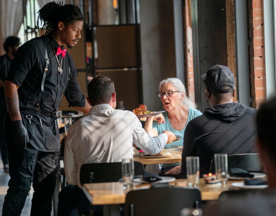 Server Hunter Stewart of Vigilante Kitchen brings a Waygu Skirt Steak on Thursday, June 29, 2023. This has been the dream of executive chef and owner Aaron Cozadd, who has conceptualized an immersive venue that encompasses Zen vibes, punk rock and graphic novels.