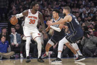 New York Knicks forward Julius Randle (30) looks for room to move as Dallas Mavericks defenders Josh Green, center, and Maxi Kleber, right, press during the first quarter of an NBA basketball game, Saturday, Dec. 3, 2022, in New York. (AP Photo/Bebeto Matthews)