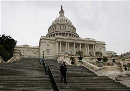 A U.S. Capitol police officer walks down the West Front steps of the U.S. Capitol in Washington October 7, 2013. REUTERS/Jason Reed