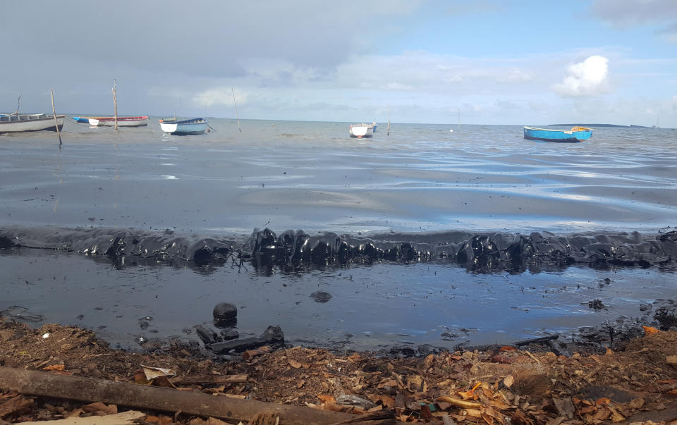 This photo taken and provided by Sophie Seneque, shows oil polluting the foreshore of the public beach in Riviere des Creoles, Mauritius, Saturday Aug. 8, 2020, after it leaked from the MV Wakashio, a bulk carrier ship that recently ran aground off the southeast coast of Mauritius. Thousands of students, environmental activists and residents of Mauritius are working around the clock to reduce the damage done to the Indian Ocean island from an oil spill after a ship ran aground on a coral reef. Shipping officials said an estimated 1 ton of oil from the Japanese ship’s cargo of 4 tons has escaped into the sea. Workers were trying to stop more oil from leaking, but with high winds and rough seas on Sunday there were reports of new cracks in the ship's hull. (Sophie Seneque via AP)