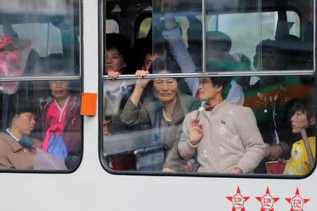 People look out from inside a tram passing by a department store in central Pyongyang, North Korea May 4, 2016. REUTERS/Damir Sagolj