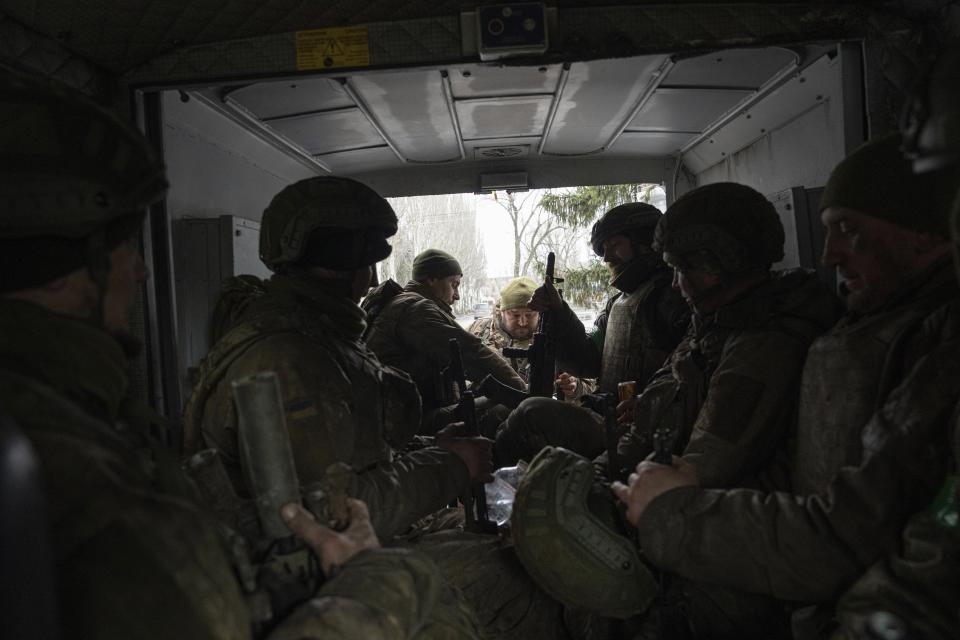 Ukrainian servicemen sit inside a van in Chasiv Yar, Ukraine, Wednesday, March 8, 2023. (AP Photo/Evgeniy Maloletka)