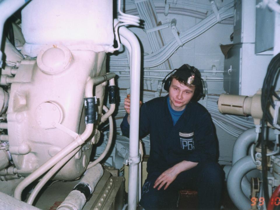 Russian sailor Maxim Rvanin sits at his workspace inside the Russian submarine K-141 Kursk.