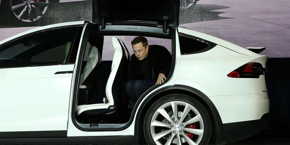 Tesla CEO Elon Musk steps out of the new Tesla Model X during an event to launch the company's new crossover SUV on September 29, 2015 in Fremont, California.