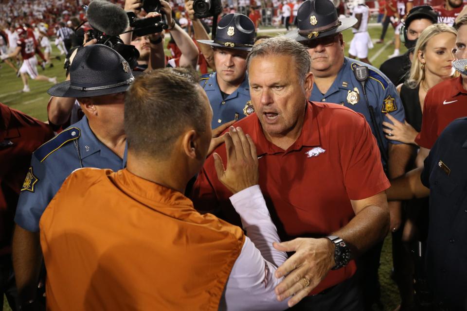 Sep 11, 2021; Fayetteville, Arkansas, USA; Arkansas Razorbacks head coach Sam Pittman talks to Texas Longhorns head coach Steve Sarkisian after the game at Donald W. Reynolds Razorback Stadium. Arkansas won 40-21.