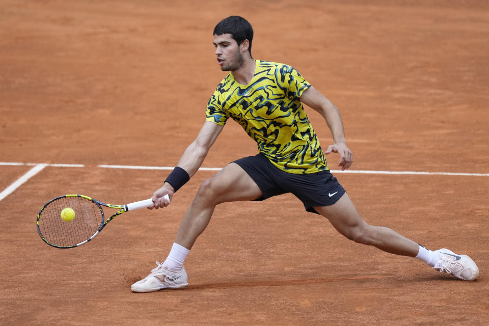 Carlos Alcaraz returns the ball to Fabian Marozsan at the Italian Open tennis tournament, in Rome, Monday, May 15, 2023. (AP Photo/Andrew Medichini)