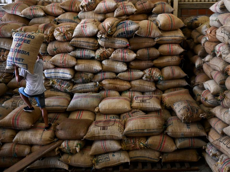 A man carries coffee bags at a cooperative in Santuario municipality, Risaralda department, Colombia on May 11, 2019