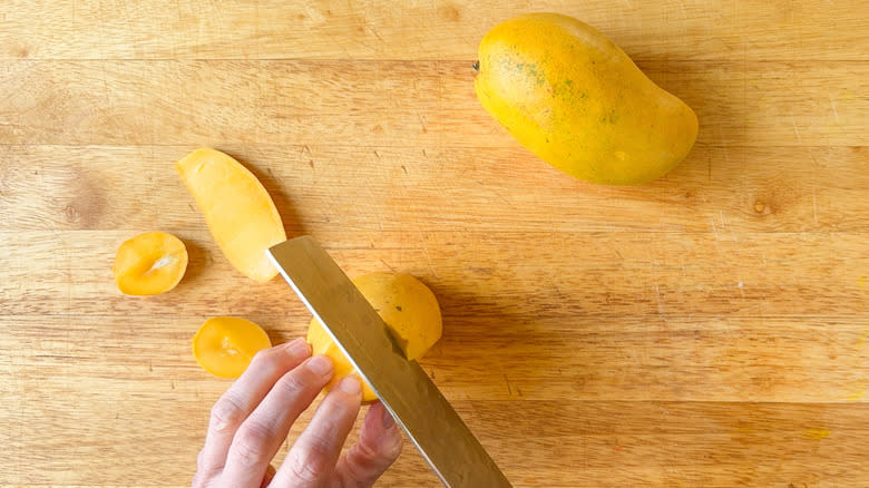 knife slicing mangoes