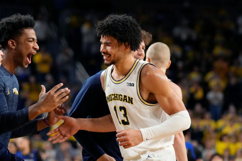 Michigan forward Olivier Nkamhoua is greeted by guard Jace Howard after a play during the first half of U-M's 99-74 win on Tuesday, Nov. 7, 2023, at Crisler Center.
