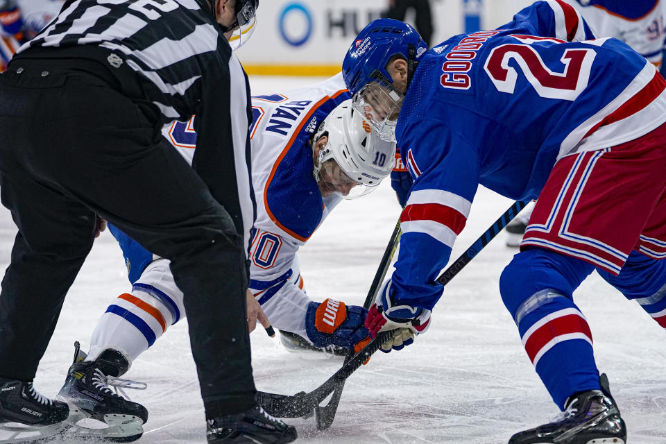 Edmonton Oilers center Derek Ryan (10) and New York Rangers center Barclay Goodrow (21) face off during the first period of an NHL hockey game in New York, Friday, Dec. 22, 2023. (AP Photo/Peter K. Afriyie)