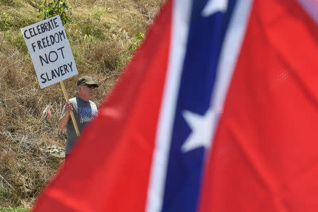 A man protests during a dedication ceremony for a Civil War Confederate Soldier Memorial in Brandenburg, Kentucky, U.S. May 29, 2017. The memorial was recently removed from the campus of the University of Louisville. REUTERS/Bryan Woolston