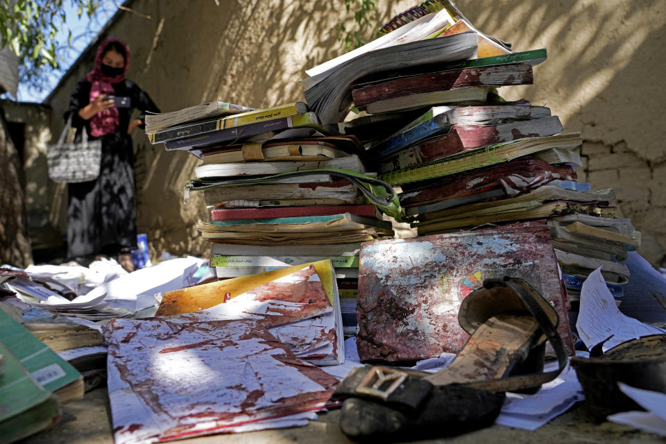 Bloody books and personal effects are left at the site of Friday's suicide bombing at a Hazara education center, in Kabul, Afghanistan, Saturday, Oct. 1, 2022. Last week’s suicide bombing at the Kabul education center killed as many as 52 people, more than double the death toll acknowledged by Taliban officials, according to a tally compiled by The Associated Press on Monday. Dozens more were injured in Friday's blast, making it one of the bloodiest attacks since the Taliban seized control of Afghanistan more than a year ago. (AP Photo/Ebrahim Noroozi)