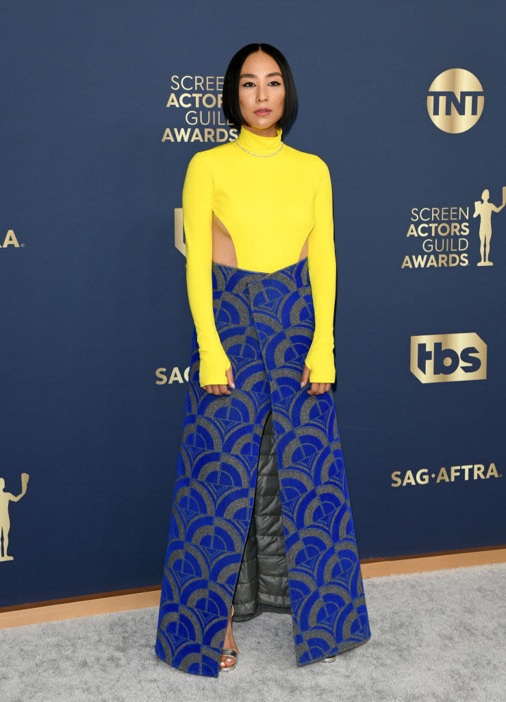 a bright turtleneck bodysuit and an insulated skirt with a unique pattern and slit