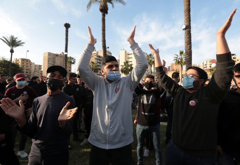 Demonstrators gesture during a protest against the fall in Lebanese pound currency and mounting economic hardships, in Sidon