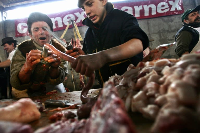 Farmers making sausages in a butchers' contest in the Serbian village of Ravno Selo