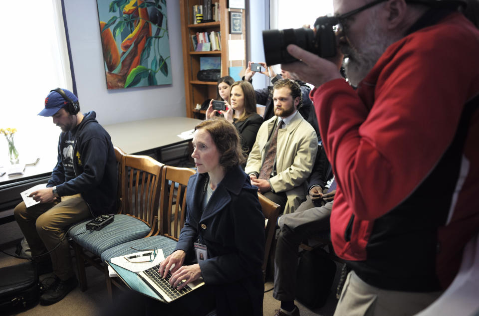 In this Tuesday, April 9, 2019 photo Berkshire Eagle reporter Heather Bellows, seated center, and Eagle photographer Ben Garver, standing at right, attend a news conference with Berkshire County District Attorney Andrea Harrington, not shown, in Pittsfield, Mass. Bellow was recruited as an investigative reporter two years ago as part of a hiring flurry that brought dozens of new jobs to The Berkshire Eagle and its three sister Vermont papers. (AP Photo/Steven Senne)