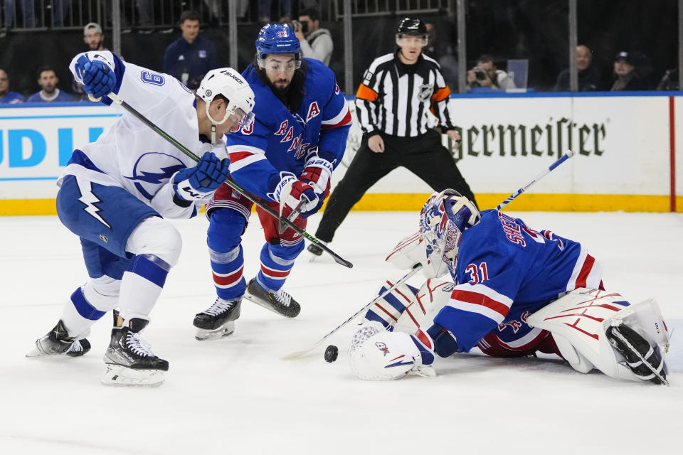 New York Rangers goaltender Igor Shesterkin (31) and Mika Zibanejad (93) stop a shot by Tampa Bay Lightning's Ross Colton (79) during the first period of an NHL hockey game Wednesday, April 5, 2023, in New York. (AP Photo/Frank Franklin II)