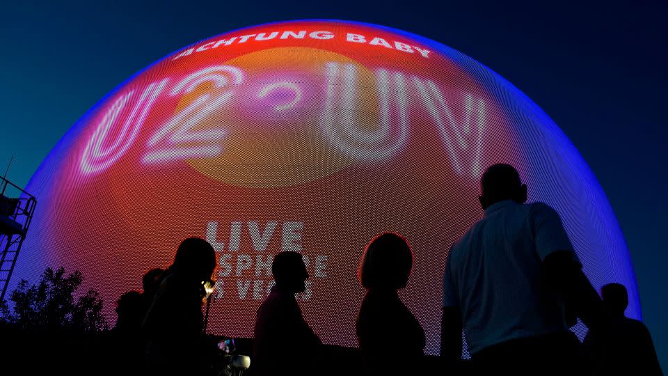 People arrive for the opening night of U2'S "UV Achtung Baby" show on Friday at the new Sphere venue in Las Vegas.  - John Locher/AP