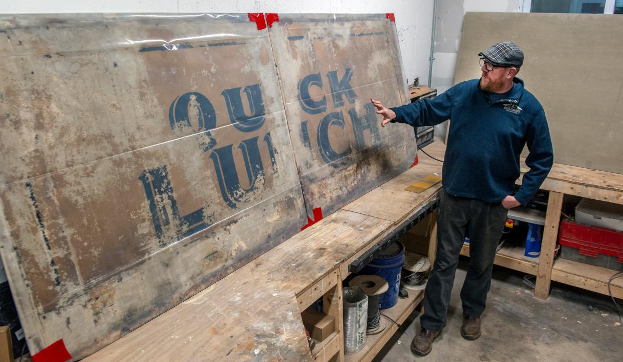 Duane Houghton, of Framingham-based Early American Restoration, with the Casey's Diner original painted exterior "Quick Lunch" panels that were discovered during repairs after a car crashed into the Natick diner. The panels are believed to be the last original siding from any Worcester Lunch Car Co. cars in the country. Houghton is re-creating the panels and the etched glass windows.
