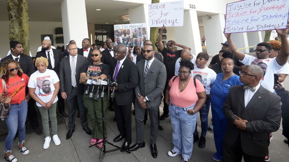 DeAsia Harmon is seen to the left of attorney Ben Crump, center, during a Monday news conference outside the Milwaukee hotel where D’Vontaye Mitchell died in June. - Ebony Cox/Milwaukee Journal Sentinel/USA Today Network