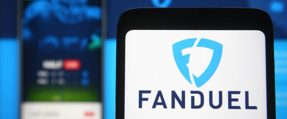 In this photo illustration FanDuel logo of a sports betting company is seen on a mobile phone screen in front of FanDuel website on background.