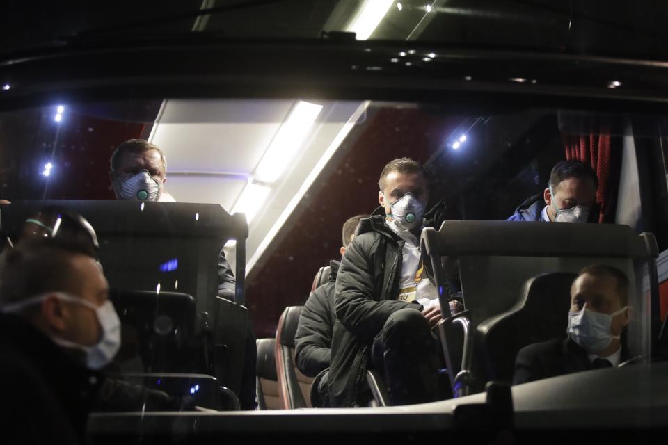 Bulgarian soccer team Ludogorets wearing protective face masks sit on a coach bus heading to the San Siro stadium, in Milan, Italy, Thursday, Feb. 27, 2020. Ludogorets is playing Italian club Inter Milan in a Europa League soccer match on Thursday that is scheduled to go ahead in an empty stadium due to the coronavirus outbreak. (AP Photo/Luca Bruno)